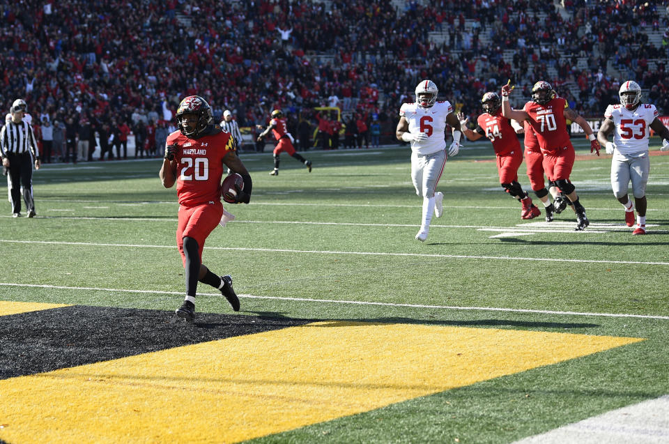 Maryland running back Javon Leake (20) scores a touchdown during the first half of an NCAA football game as Ohio State defensive tackle Taron Vincent (6) pursues, Saturday, Nov. 17, 2018, in College Park, Md. (AP Photo/Nick Wass)