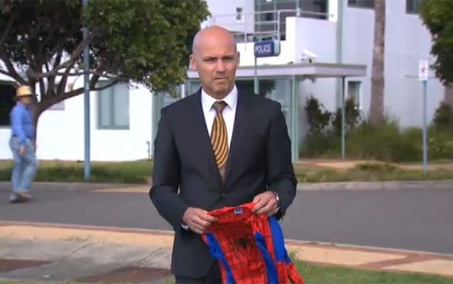 Detective Inspector Gary Jubelin holds a spider-man costume like the one William Tyrrell was wearing when he vanished. Source: 7 News.