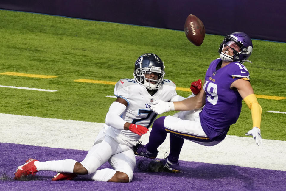 Tennessee Titans cornerback Malcolm Butler, left, breaks up a pass intended for Minnesota Vikings wide receiver Adam Thielen (19) in the end zone during the first half of an NFL football game, Sunday, Sept. 27, 2020, in Minneapolis. (AP Photo/Jim Mone)