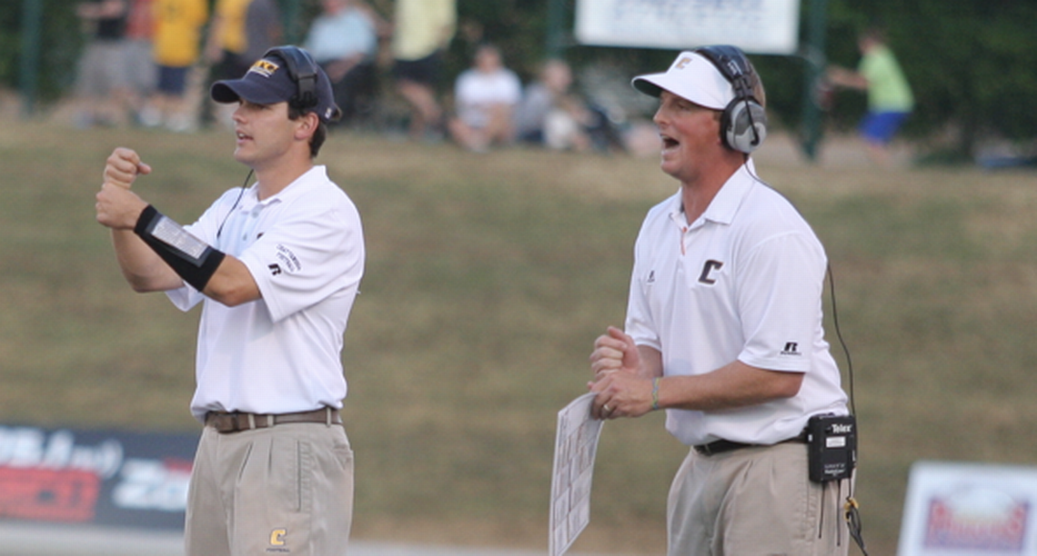 South Carolina OC Marcus Satterfield (right) and Charlotte head coach Will Healy signal in a play during their time on staff at UT-Chattanooga.