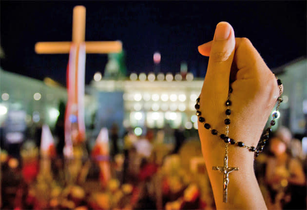 A woman holds a rosary during a rally: AFP/GETTY IMAGES