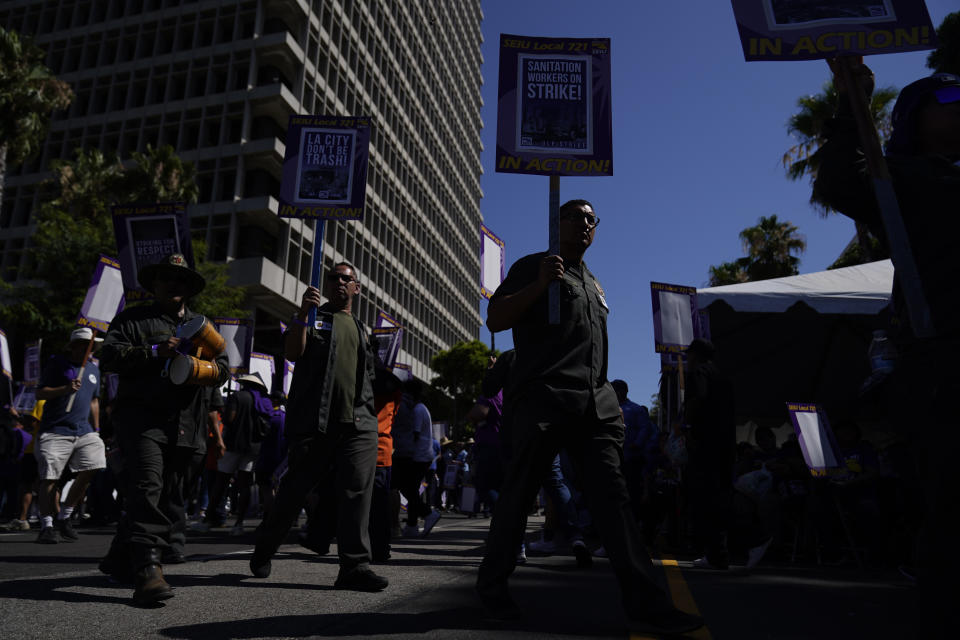 Workers picket outside of City Hall, Tuesday, Aug. 8, 2023, in Los Angeles. Thousands of Los Angeles city employees, including sanitation workers, engineers and traffic officers, walked off the job for a 24-hour strike alleging unfair labor practices. The union said its members voted to authorize the walkout because the city has failed to bargain in good faith and also engaged in labor practices that restricted employee and union rights. (AP Photo/Ryan Sun)