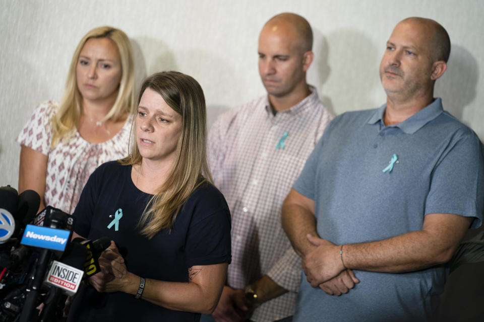 Nicole Schmidt, mother of Gabby Petito, whose death on a cross-country trip has sparked a manhunt for her boyfriend Brian Laundrie, speaks alongside, from left, Tara Petito, stepmother, Jim Schmidt, stepfather, and Joseph Petito, father, during a news conference.