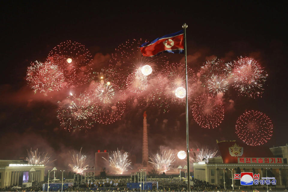 In this photo provided by the North Korean government, fireworks illuminate the night sky, marking the New Year, as crowds of people look on, at Kim Il Sung Square in Pyongyang, North Korea, early Friday, Jan. 1, 2021. (Korean Central News Agency/Korea News Service via AP)