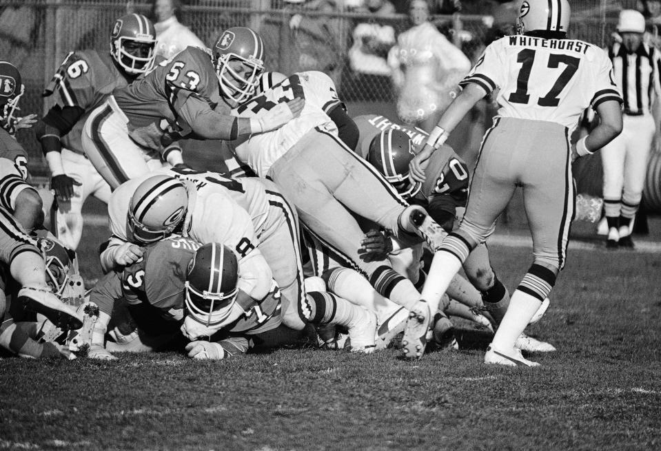 Randy Gradishar (53) of the Denver Broncos leads the defensive surge during a game against the Green Bay Packers on Jan. 11, 1979.
