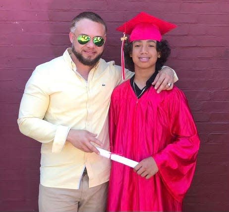 Former New York Mets infielder Argenis Reyes with his son Delvison in 2019 at Delvison's eighth-grade graduation. The younger Reyes is now a senior baseball player at Eastside High School.