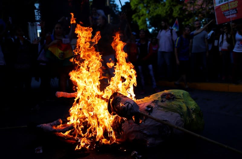 An effigy depicting U.S. President, Donald Trump is set on fire by supporters of Bolivia's ousted President Evo Morales outside the U.S. embassy in Buenos Aires to protest against the U.S. government, in Buenos Aires