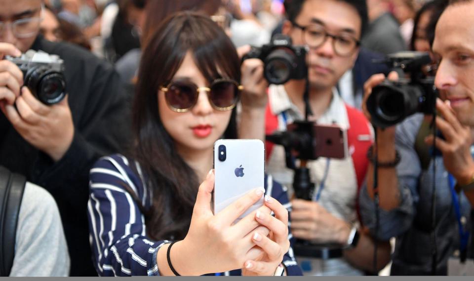 People take photos as a woman tests out a new iPhone X during a media event at Apple's new headquarters in Cupertino, California on September 12, 2017: JOSH EDELSON/AFP/Getty Images