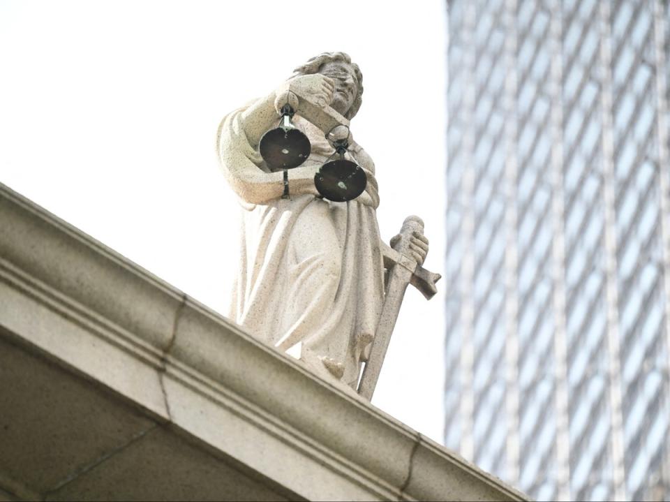 The scales of justice are seen on top of the Court of Final Appeal in Hong Kong on 24 June 2024 (AFP via Getty Images)