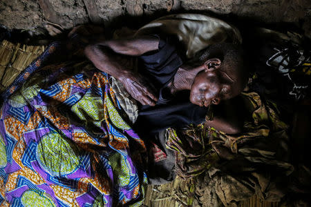 A woman, 60, who is suffering from malaria rests in her house at Kagorwa Pygmy camp on Idjwi island in the Democratic Republic of Congo, November 22, 2016. The woman died from her illness a few days later. REUTERS/Therese Di Campo