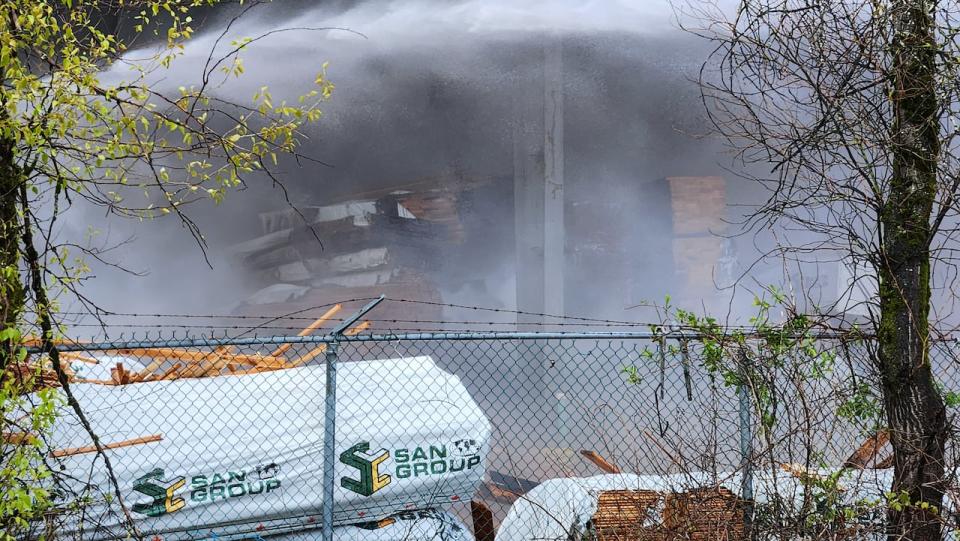 A large pile of burned lumber was visible at the mill on Sunday morning. Crews say they were tackling multiple blazes at the mill near the Fraser Surrey docks.