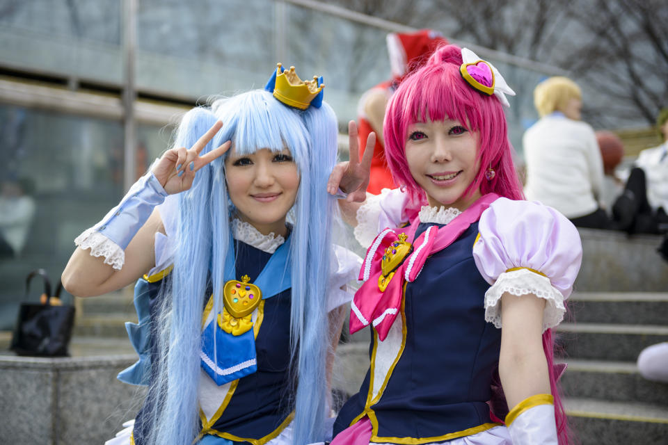 Tokyo, Japan - March 23, 2014: Two young women pose in costume at a cosplay gathering. The phenomenon of cosplay is a significant aspect of Japanese pop culture which grew rapidly in the 1990's.