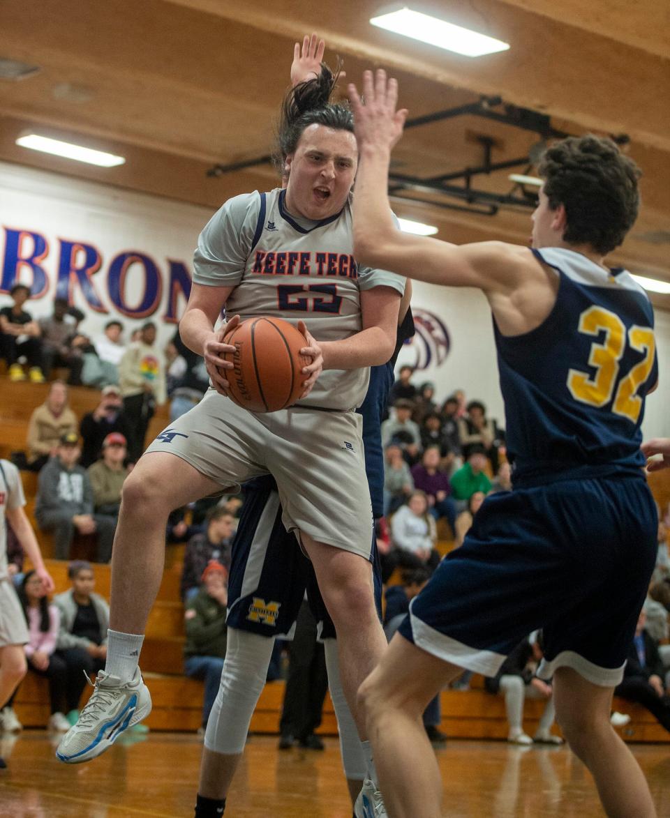 Keefe Tech junior captain Logan Greenlaw pulls down a rebound against Minuteman Tech in the home opener, Dec. 14, 2023. The Broncos won, 68-38.