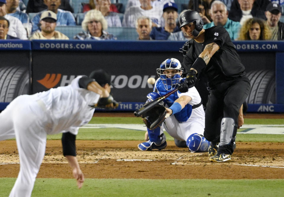 New York Yankees' Gary Sanchez, right, hits a solo home run off Los Angeles Dodgers starting pitcher Hyun-Jin Ryu, left, of South Korea, during the third inning of a baseball game Friday, Aug. 23, 2019, in Los Angeles. (AP Photo/Mark J. Terrill)