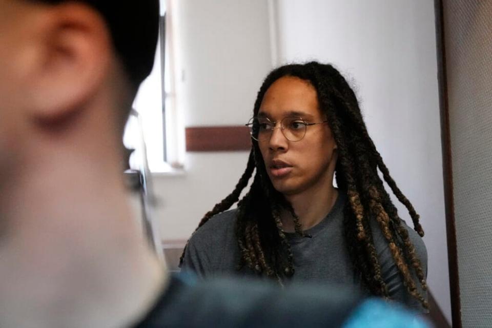 WNBA star and two-time Olympic gold medalist Brittney Griner is escorted to a courtroom for a hearing, in Khimki just outside Moscow, Russia, Monday, June 27, 2022. More than four months after she was arrested at a Moscow airport for cannabis possession, American basketball star Brittney Griner is to appear in court Monday for a preliminary hearing ahead of her trial. (AP Photo/Alexander Zemlianichenko)