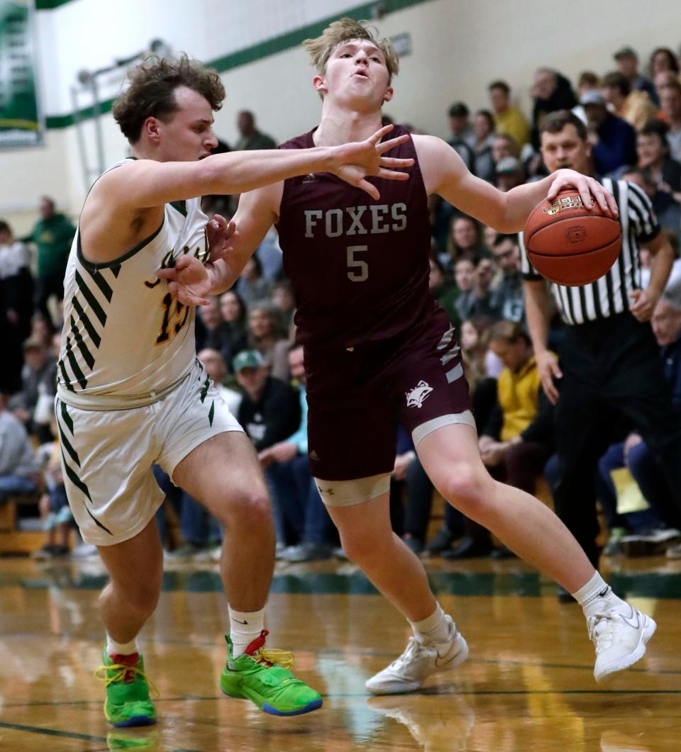 Freedom's Owen Wedin, left, defends against Fox Valley Lutheran's Adam Loberger during their basketball game Feb. 13 in Freedom.