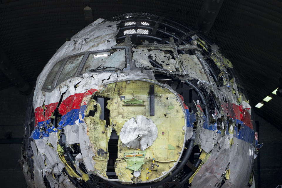 FILE- In this Wednesday, May 26, 2021, file photo the reconstructed wreckage of Malaysia Airlines Flight MH17, is shown at the Gilze-Rijen Airbase, southern Netherlands. The trial in absentia in a Dutch courtroom of three Russians and a Ukrainian charged in the downing of Malaysia Airlines flight MH17 in 2014 moves to the merits phase, when judges and lawyers begin assessing evidence. (AP Photo/Peter Dejong, File)