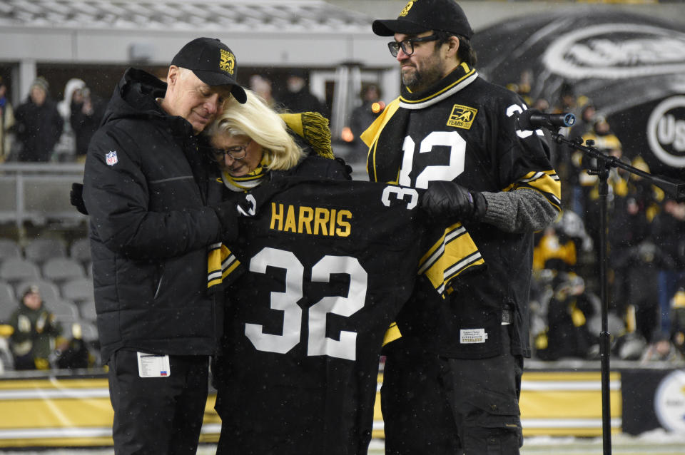 Pittsburgh Steelers owner Art Rooney II, left, and Franco Harris' widow Dana, center, and son Dok, attend a ceremony to retire Harris' No. 32 jersey at half-time of an NFL football game against the Las Vegas Raiders, Saturday, Dec. 24, 2022. Harris, a four-time Super Bowl champion, passed away Dec. 21, 2022, at the age of 72. (AP Photo/Don Wright)