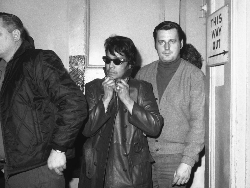 Dollree Mapp, 42, who was involved in a landmark U.S. Supreme Court decision concerning illegal search and seizure in 1961, is escorted into 105th Precinct in New York by Det. John Bergersen, Feb. 18, 1970.