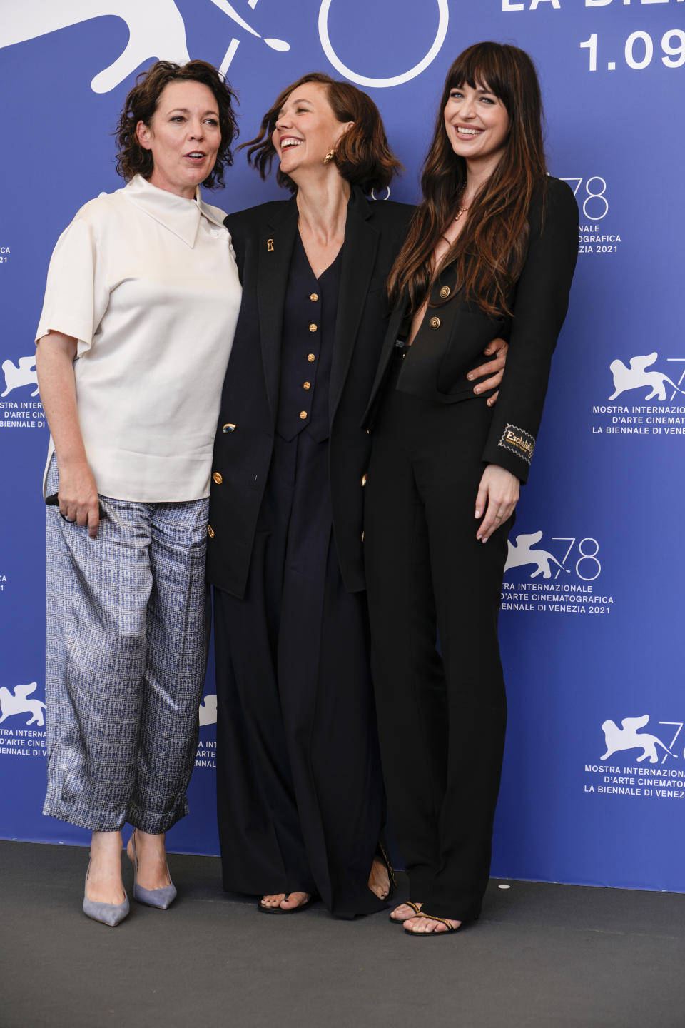 Olivia Colman, from left, Maggie Gyllenhaal and Dakota Johnson pose for photographers at the photo call for the film 'The Lost Daughter' during the 78th edition of the Venice Film Festival in Venice, Italy, Friday, Sep, 3, 2021. (AP Photo/Domenico Stinellis)