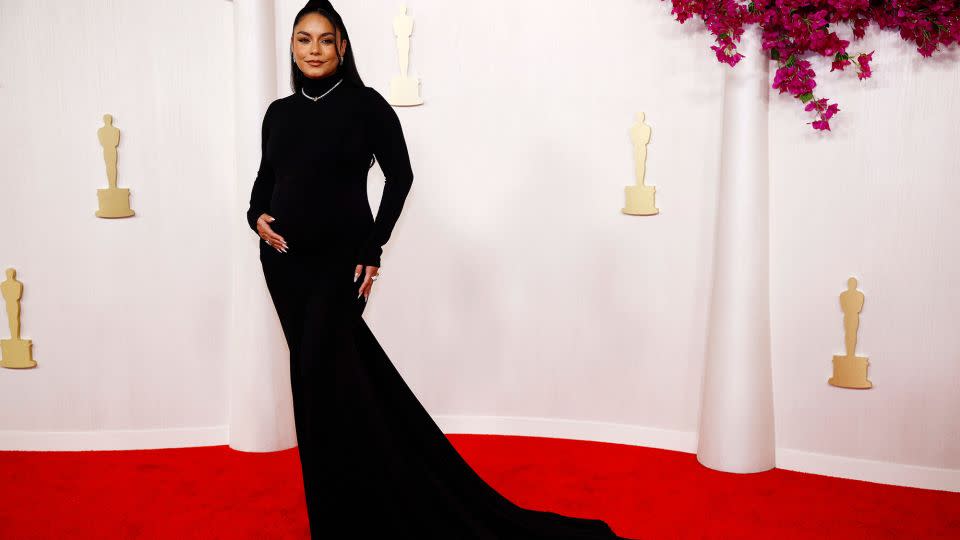 Vanessa Hudgens, wearing a form-fitting Vera Wang gown, debuted her baby bump on the red carpet. She completed the look with Chopard jewelry. - Sarah Meyssonnier/Reuters
