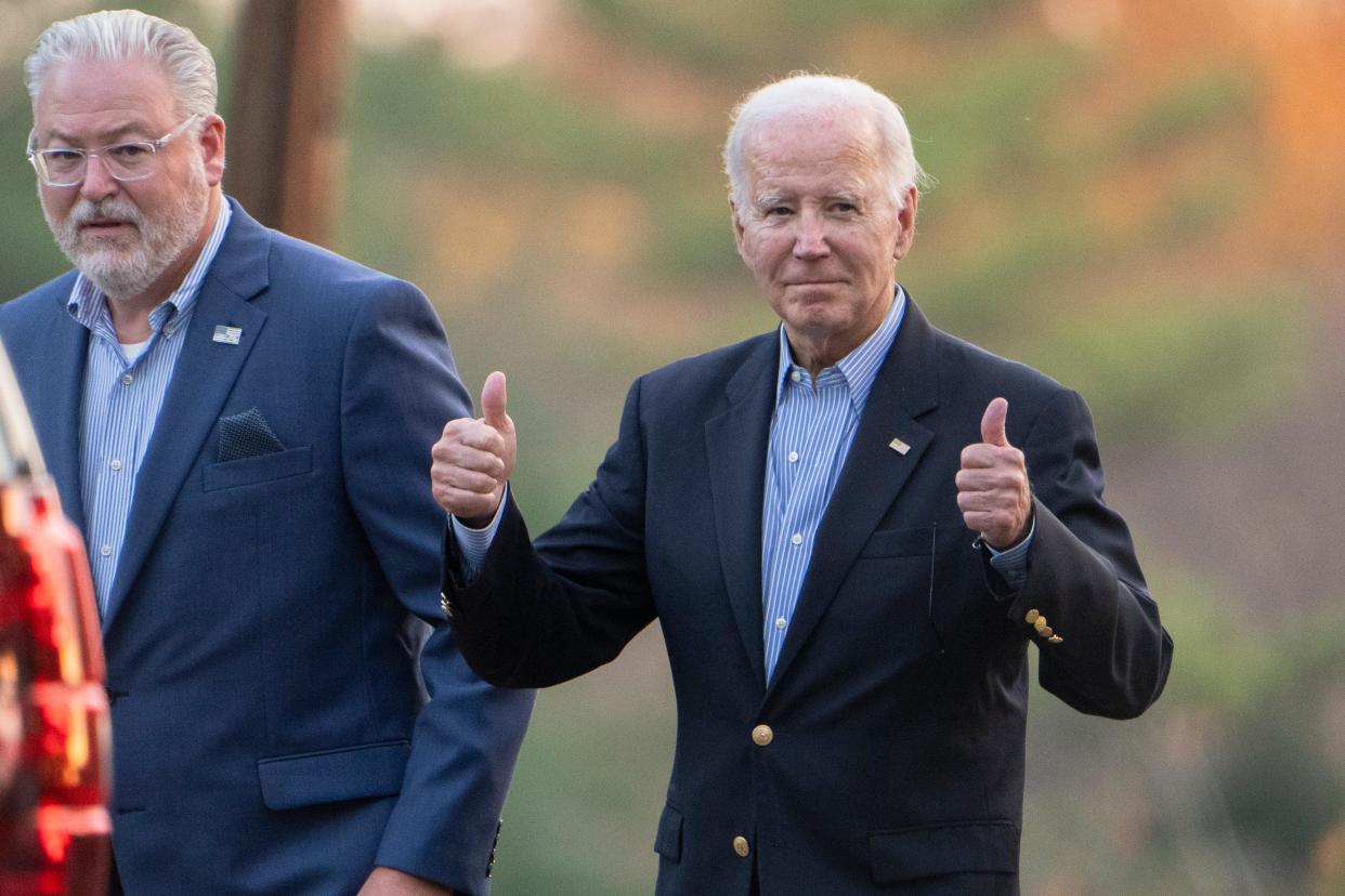 President Joe Biden gestures with two thumbs up responding to a question from the media about the UAW deal as he leaves St. Joseph on the Brandywine Catholic Church in Greenville on Saturday, Oct. 28, 2023.