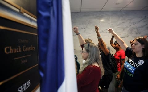 Demonstrators outside the office of Senator Chuck Grassley, a Republican from Iowa and chairman of the Senate Judiciary Committee, during a protest against the nomination of Brett Kavanaugh - Credit: Bloomberg
