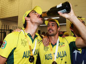 Mitchell Starc and Mitchell Johnson share a drink.