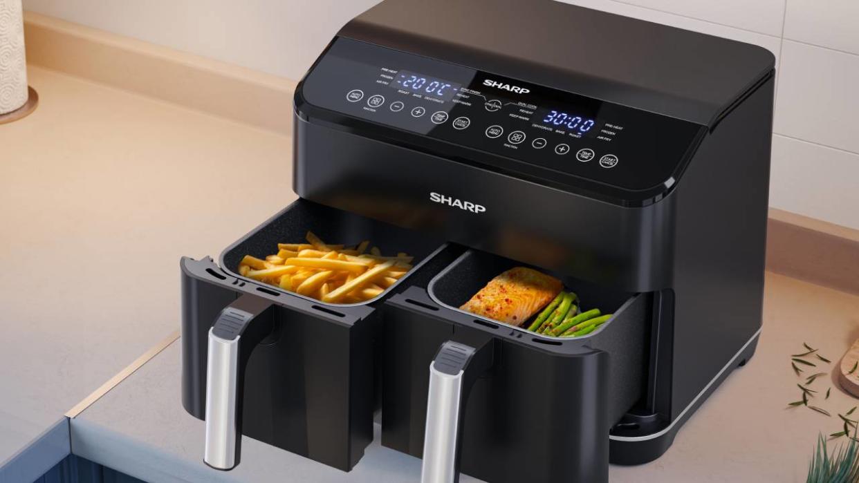  Lifestyle image of the Sharp Dual Drawer Air Fryer AF-GD82AE open with food in the two compartments. 