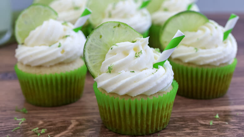 spiked margarita cupcakes on a wooden table