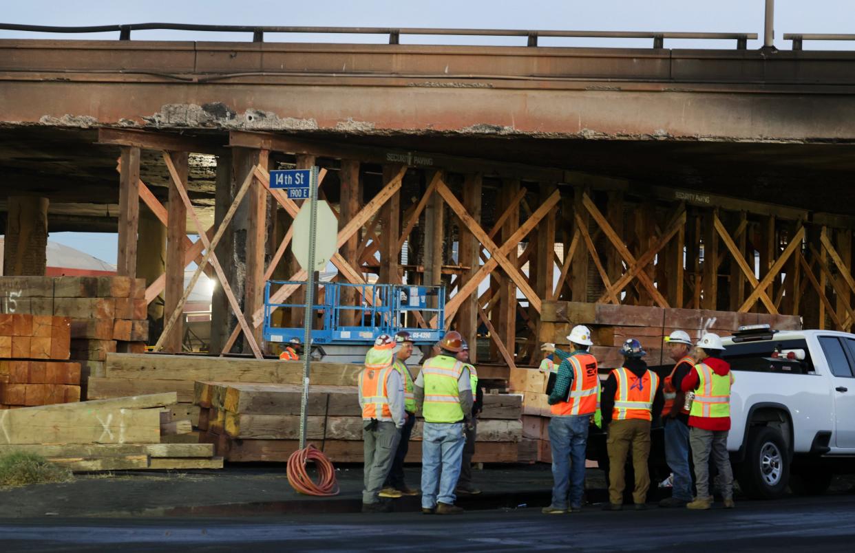 Construction workers work underneath the Interstate 10 freeway on Nov. 14, 2023. A fire under the freeway severely damaged the overpass in an industrial zone near downtown Los Angeles on Saturday, Nov. 11, 2023. The large blaze burned trailers, cars and other things in storage lots beneath a major highway near downtown Los Angeles, forcing the temporary closure of the roadway.