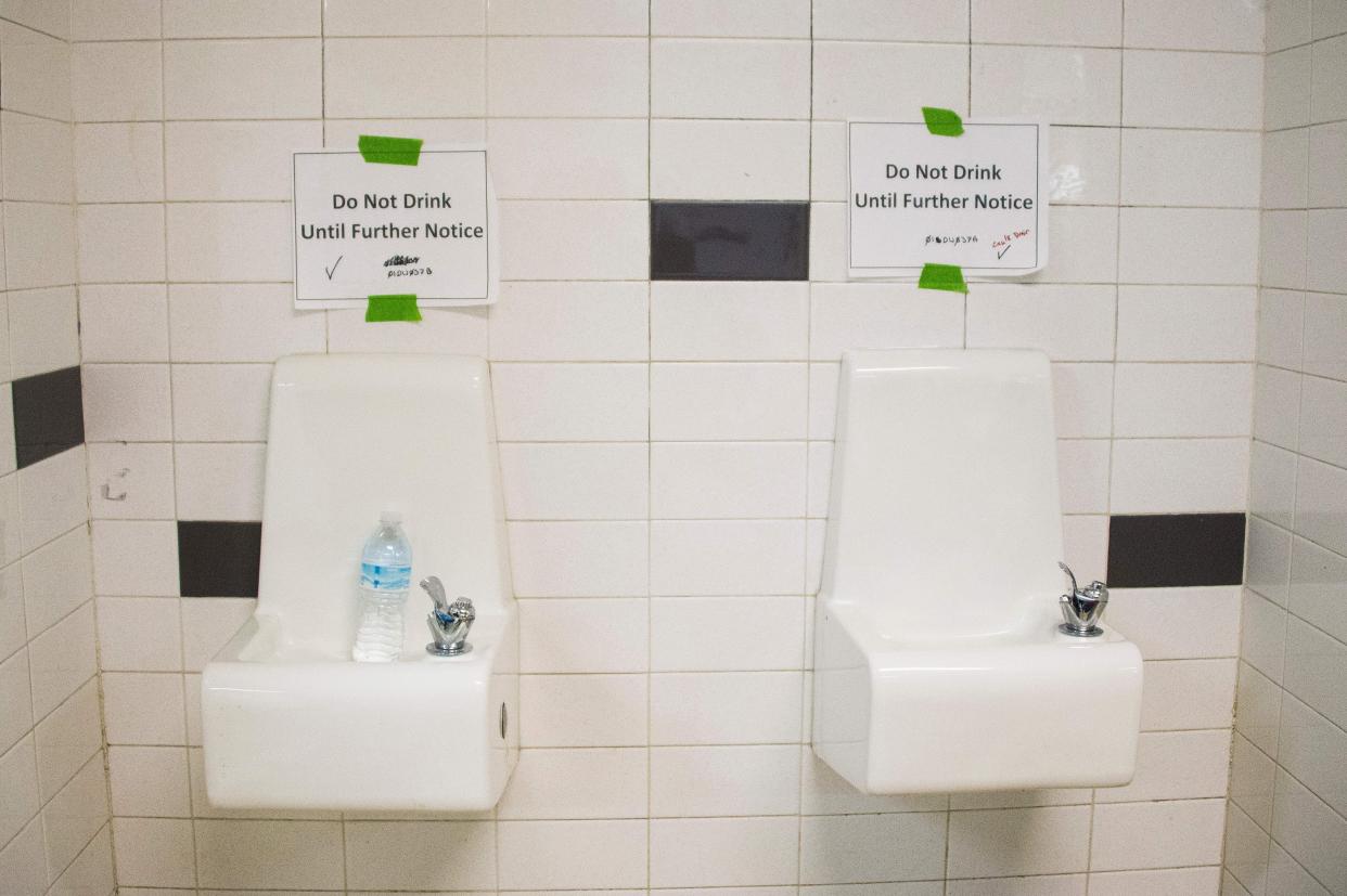 Placards posted above water fountains warn against drinking the water at Flint Northwestern High School in Flint, Michigan, on May 4, 2016. (Photo: JIM WATSON via Getty Images)