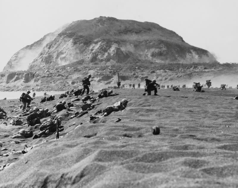 U.S. Marines with the Fifth Division move inland off the landing beach after coming ashore on Iwo Jima