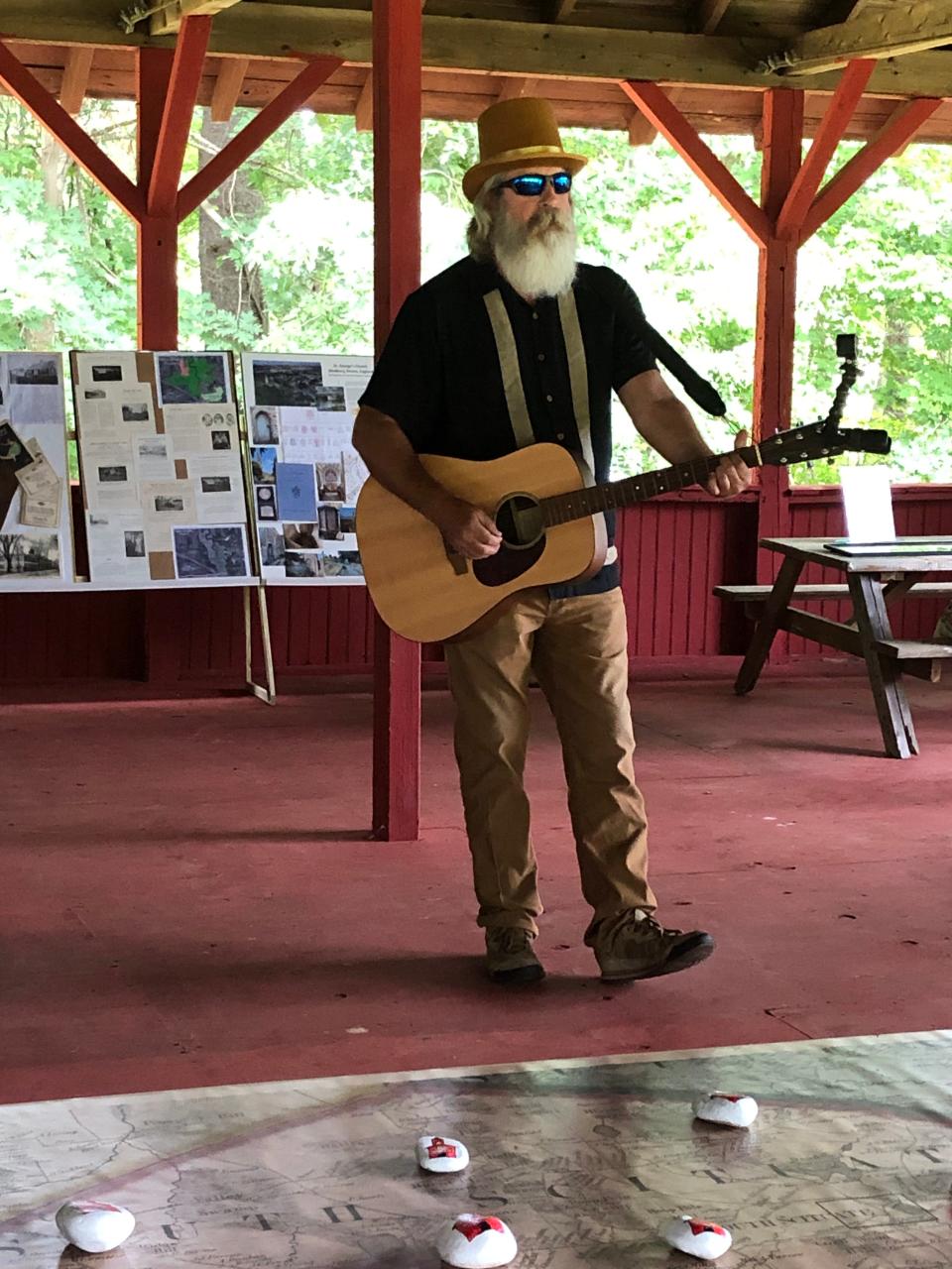 Guitarist Chris Loring sings a song written by the late Stephen Eisner for Norwell's centennial in 1988. The song was recently rediscovered on a cassette tape. Loring performed at the Stetson Homestead pavilion in Norwell for the town's Stetson Heritage Day on Aug. 19. 2023.