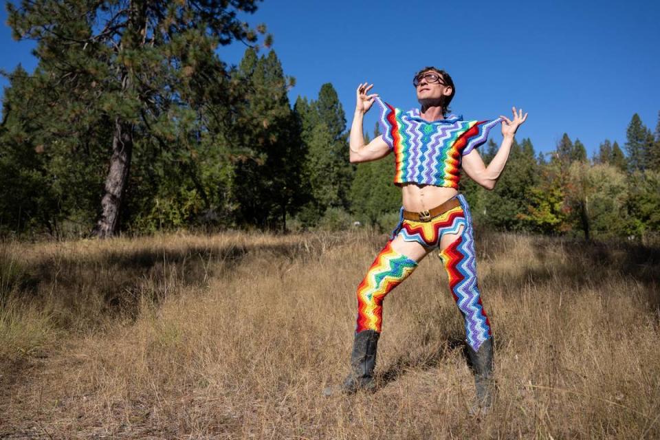 Fashion designer Schuyler Ellers models a crop top, a swimsuit and chaps leg coverings outside of his studio near Nevada City earlier this month. His clothing line, Lord von Schmitt, based on crochet blankets and throws.