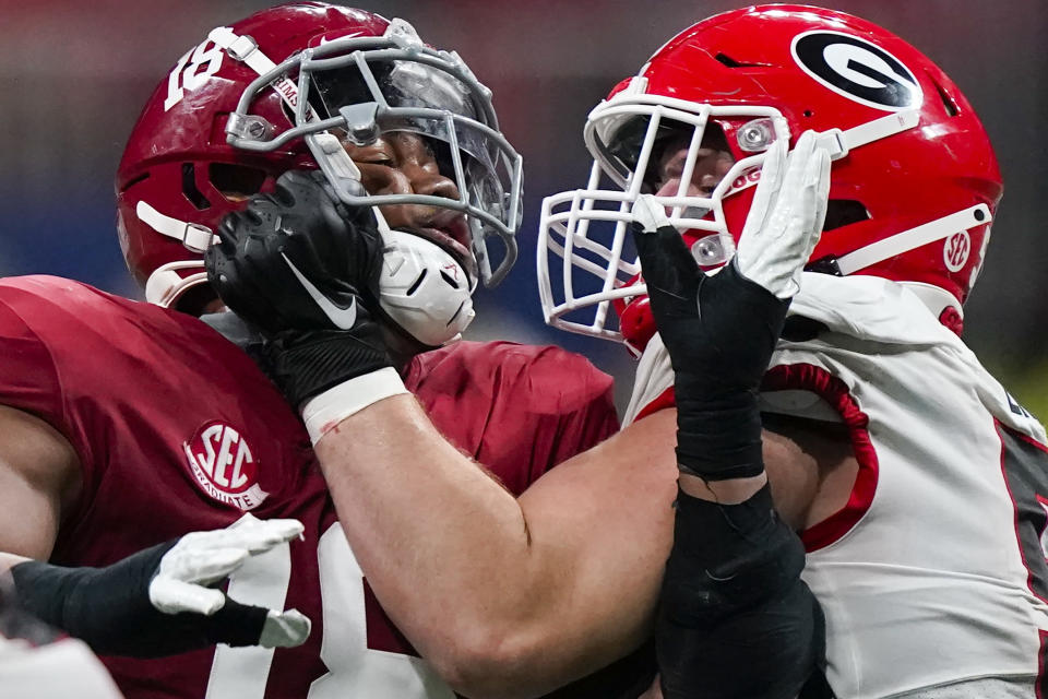 FILE - Georgia offensive lineman Warren Ericson (50) and Alabama wide receiver Slade Bolden (18) play during the second half of the Southeastern Conference championship NCAA college football game, Saturday, Dec. 4, 2021, in Atlanta. Those Georgia Bulldogs aren't the only ones having a devil of a time beating fellow Southeastern Conference powerhouse Alabama. They're just the only one that gets another shot in the biggest game of them all. (AP Photo/Brynn Anderson, File)