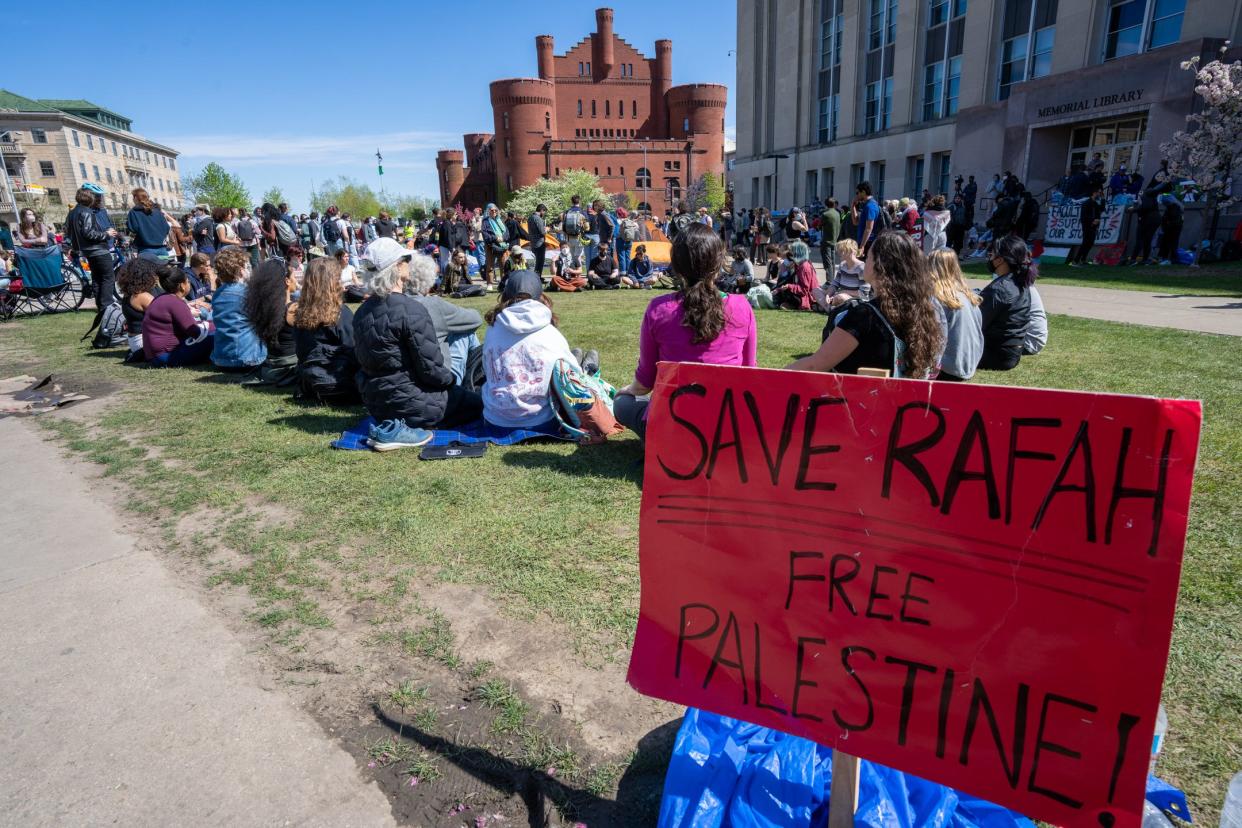 People protesting the Israel-Hamas war meditate near a tent encampment Wednesday, May 1, 2024, at the University of Wisconsin-Madison in Madison, Wisconsin. Student protesters around the country have demanded colleges cut financial ties to Israel. The latest demonstrations show growing discontent over their schools’ responses to the Israeli-Hamas war.