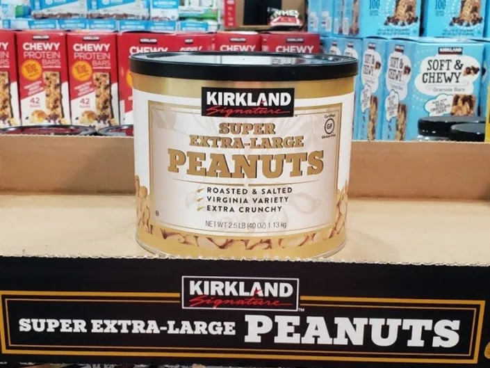 White and gold container of kirkland's extra-large peanuts at costco