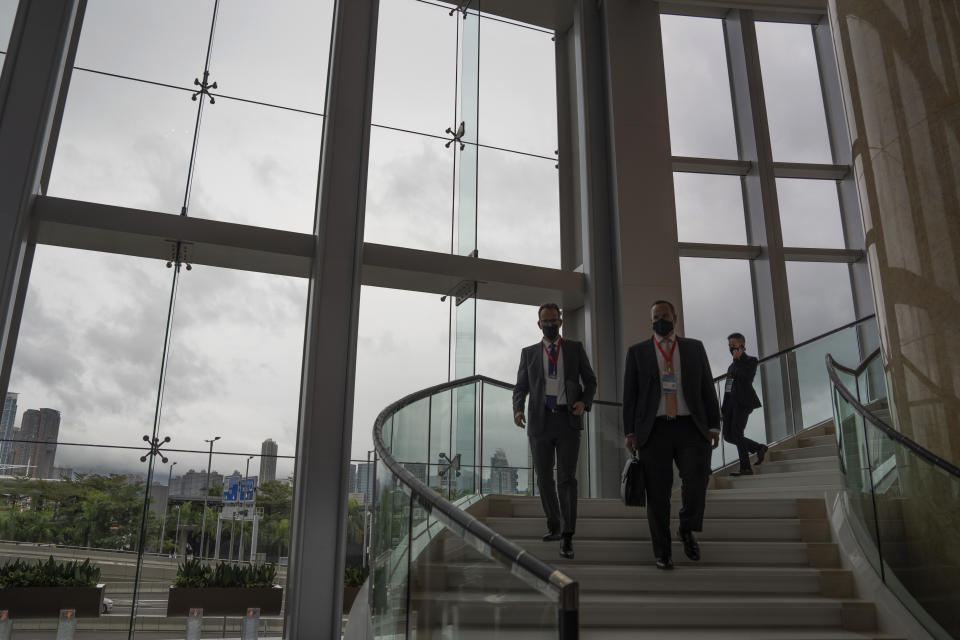 Guests leave from the Global Financial Leaders' Investment Summit in Hong Kong, Wednesday, Nov. 2, 2022. Severe tropical storm Nalgae edged closer to Hong Kong on Wednesday and forced businesses to close, but the finance summit that's meant to restore the city's image as an international financial hub pressed ahead. (AP Photo/Bertha Wang)