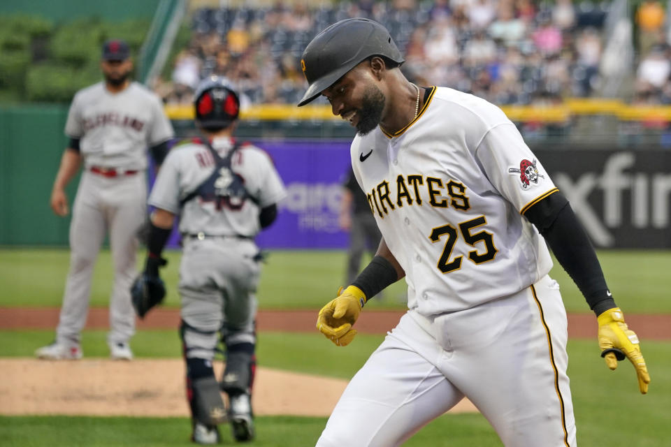 Pittsburgh Pirates' Gregory Polanco (25) returns to the dugout after hitting a two-run home run off Cleveland Indians pitcher Jean Carlos Mejia, left, during the first inning of a baseball game in Pittsburgh, Friday, June 18, 2021. (AP Photo/Gene J. Puskar)