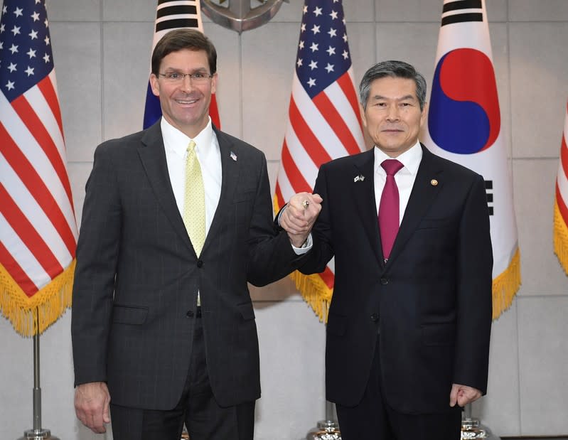 U.S. Defense Secretary Esper clasps hands with South Korean Defense Minister Jeong before their meeting in Seoul