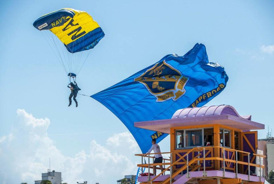 A member of the U.S. Navy Leap Frogs Parachute Team lands near a lifeguard tower during the Hyundai Air & Sea Show in Miami Beach on Saturday May 28, 2022.