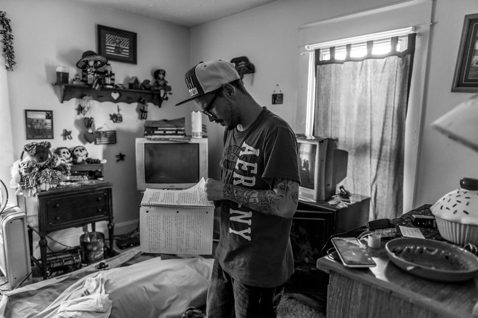 <p>Larry Fugate, a recovering heroin addict at home in Middletown, writes music: “Blues Clues couldn’t solve this — mystery. Cocaine, amphetamine, codeine dreams — a fiend.” (Photograph by Mary F. Calvert for Yahoo News) </p>