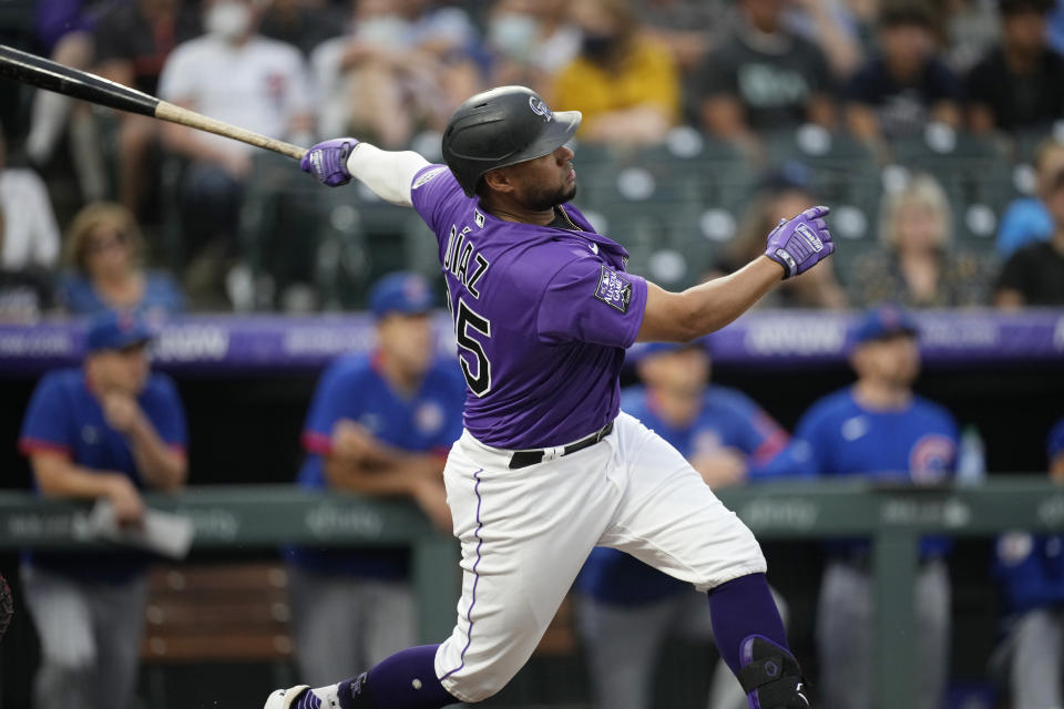 Colorado Rockies' Elias Diaz follows the flight of his grand slam off Chicago Cubs starting pitcher Zach Davies in the second inning of a baseball game Tuesday, Aug. 3, 2021, in Denver. (AP Photo/David Zalubowski)