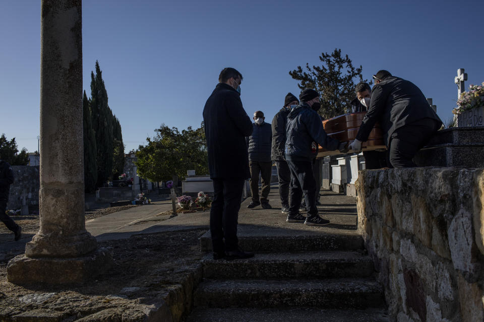 Catholic Rev. Francisco Ortega, 40, conducts a burial in Morales del Vino, in the Zamora province of Spain, on Sunday, Nov. 28, 2021. Ortega manages six parishes. trying to adapt as the number of churchgoers steadily declines. (AP Photo/Manu Brabo)