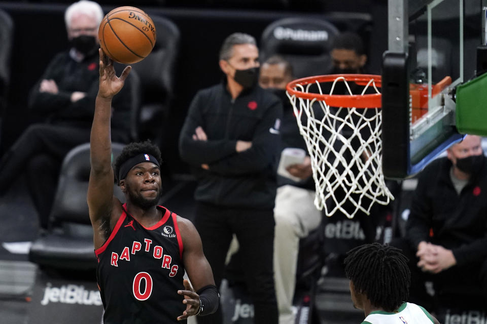 Toronto Raptors guard Terence Davis (0) shoots over Boston Celtics center Robert Williams III during the first half of an NBA basketball game, Thursday, March 4, 2021, in Boston. (AP Photo/Charles Krupa)