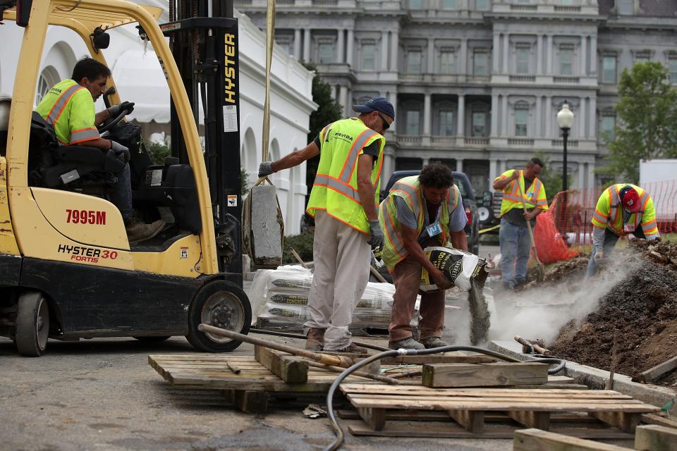 Workers of M&F Concrete pour concrete as they install granite curb on the ground of the White House in front of the West Wing August 8, 2017 in Washington, DC. (Photo by Alex Wong/Getty Images)