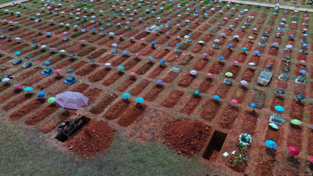 <p>File image: In this 20 March, 2021, photo, a worker digs a grave in the San Juan Bautista cemetery in Iquitos, Peru. On 31 May, 2021, Peru announced a sharp increase in its Covid-19 death toll, saying there have been more than 180,000 fatalities since the pandemic hit the country early last year</p> (AP)