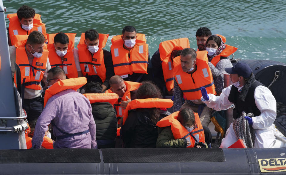 A group of people thought to be migrants are brought into port aboard a border force boat following a small boat incident in the Channel, at Dover, southern England, Wednesday July 21, 2021. The number of undocumented migrants reaching Britain in small boats this year has surpassed the total for all of 2020, as people smugglers take advantage of good weather to cross the English Channel from France. (Gareth Fuller/PA via AP)