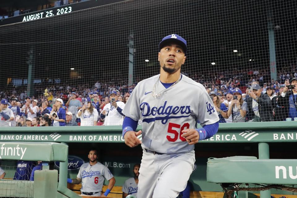 Los Angeles Dodgers' Mookie Betts heads out onto the field before the team's baseball game against the Boston Red Sox, Friday, Aug. 25, 2023, in Boston. (AP Photo/Michael Dwyer)